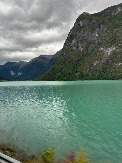       Fjord with turquoise waters and mountainous terrain.
  