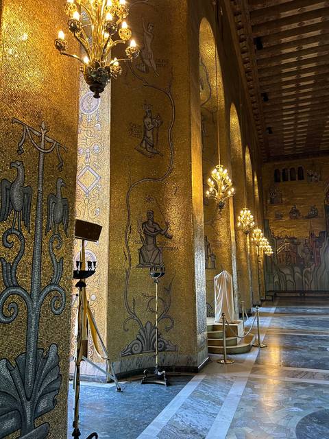       Decorated interior with gold mosaics and chandeliers.
  