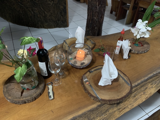       Table setting with wine, glasses, and a candle.
  