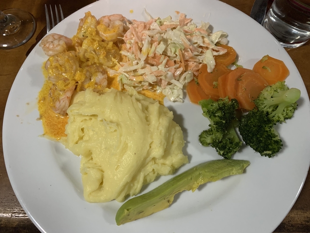       Plate of shrimp in sauce, mashed potatoes, and vegetables.
  