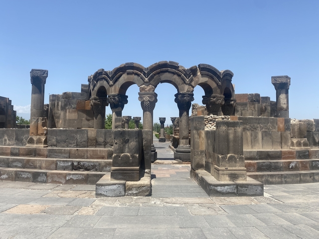       Ancient stone ruins with blue sky.
  