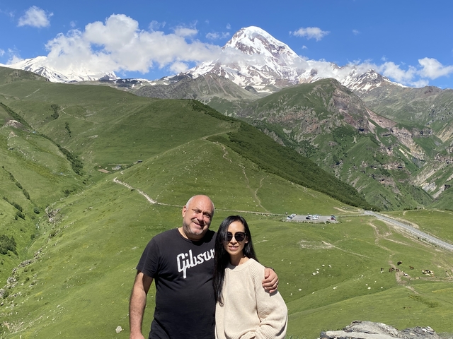       Couple with a mountainous backdrop.
  