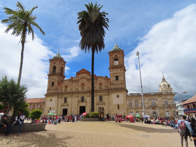       A large church with a central square filled with people.
  