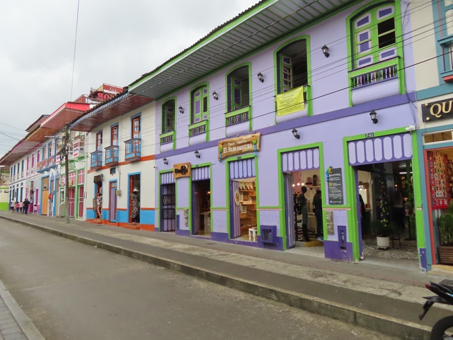       Colorful buildings along a street in a vibrant town.
  