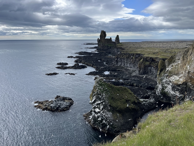       Cliffside with rock formations overlooking the ocean.
  