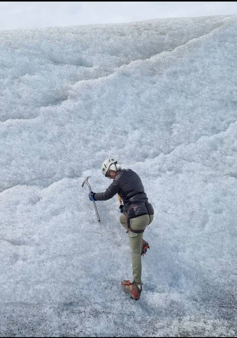 Person ice climbing on a glacier.