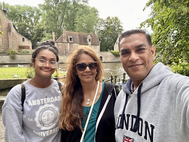 Family in front of a scenic canal.