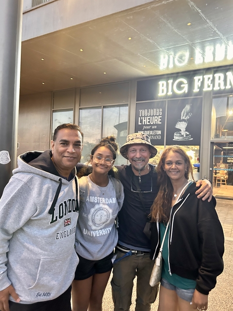       Group of people standing in front of a store.
  