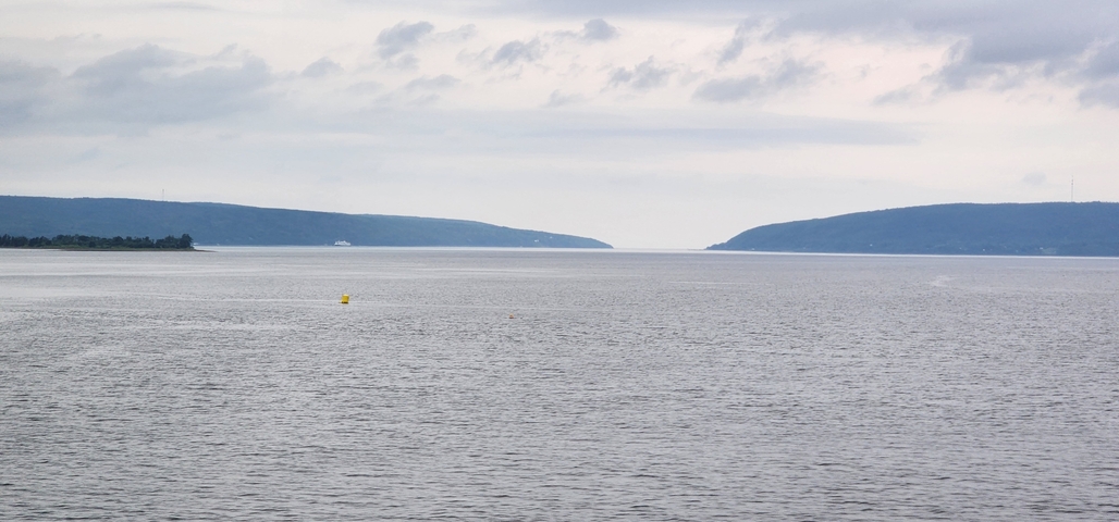 Large body of water with hills framing the horizon.