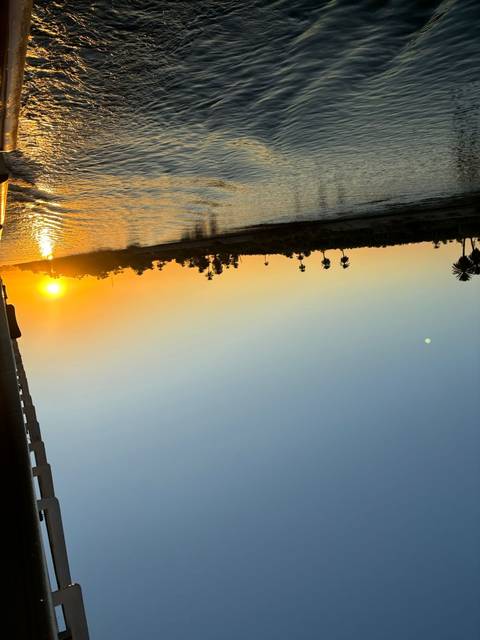 River at sunset viewed from a boat.
