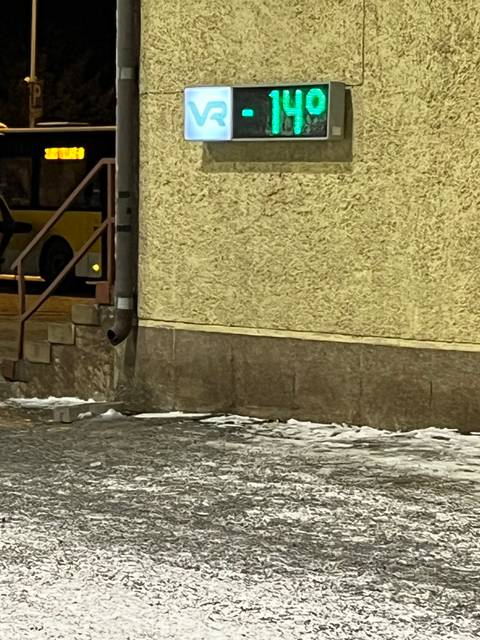 Building with sign on a snowy night.