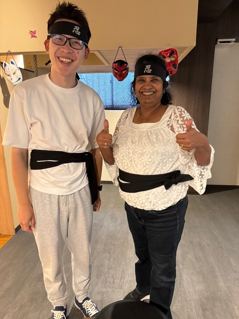 Two people showing martial arts attire indoors.