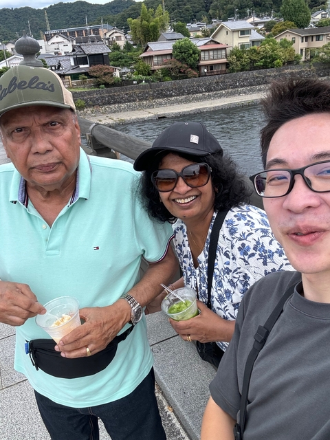 Three people enjoying drinks outdoors.
