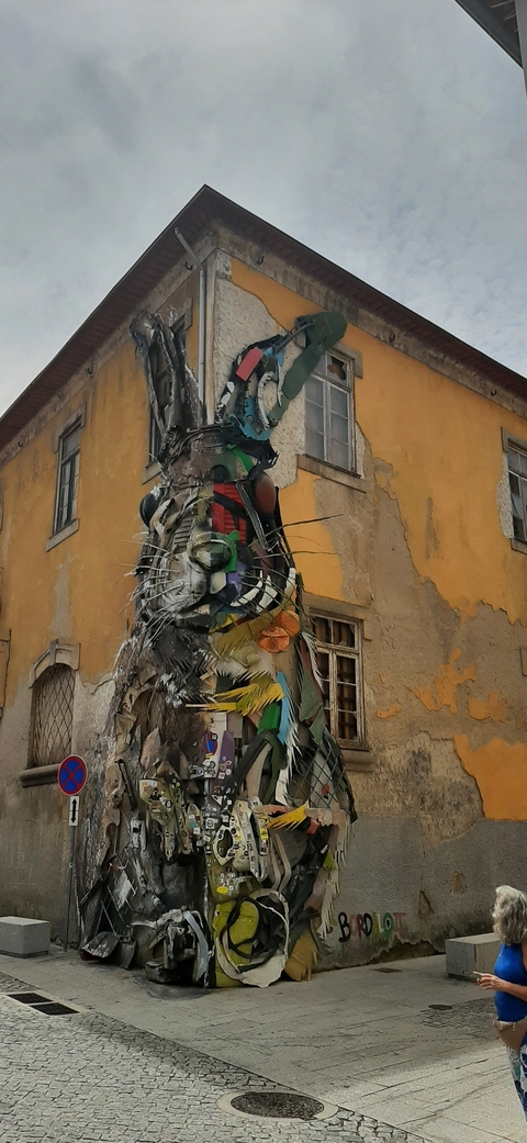       Sculpture of various objects and vibrant colors on a wall.
  