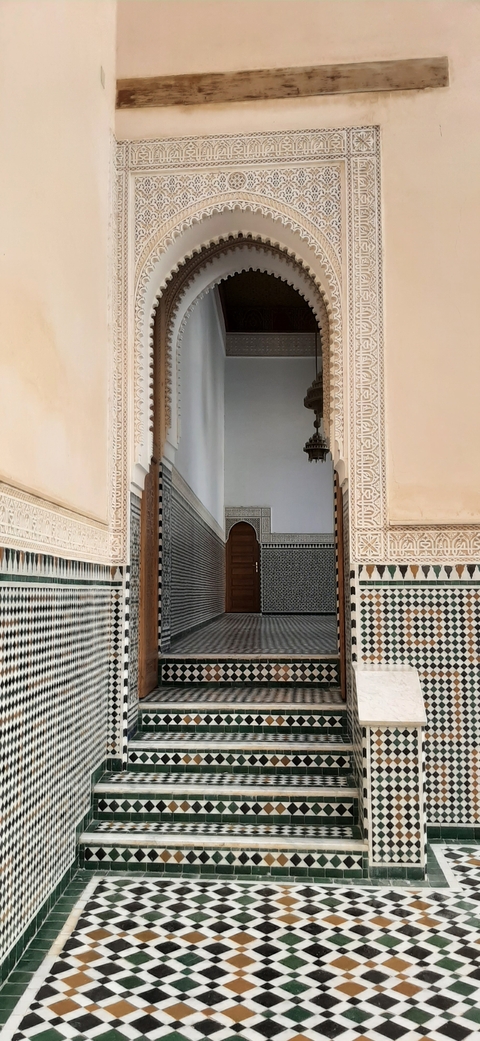       Intricately designed interior entrance with tile patterns.
  