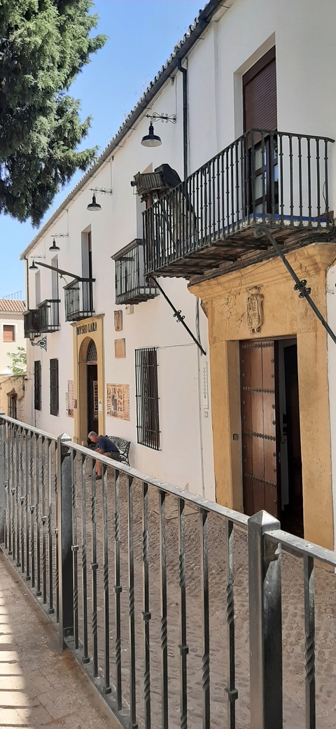 Historic building facade with wooden doors and benches.
