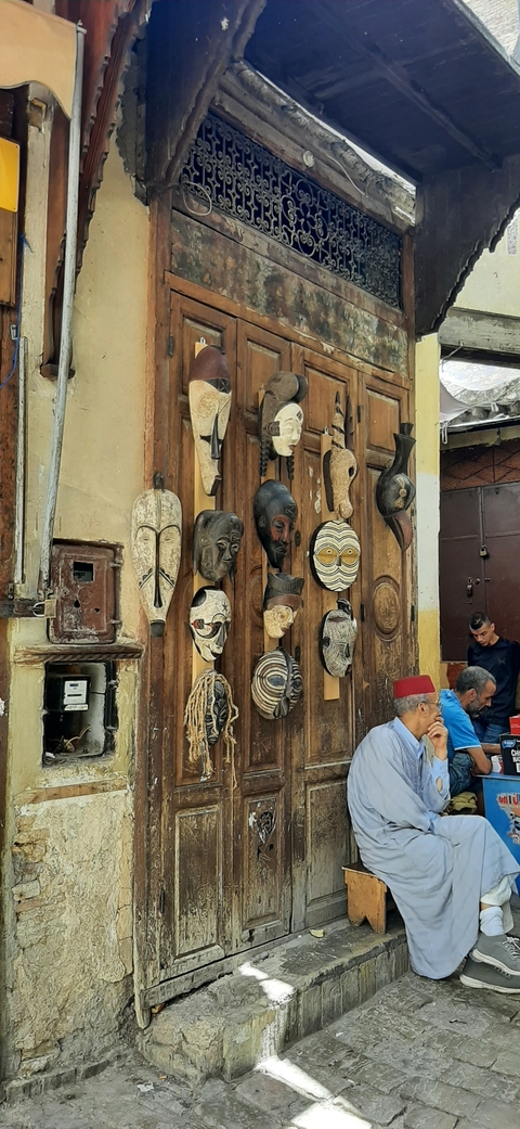 Various decorative masks displayed on a wall.