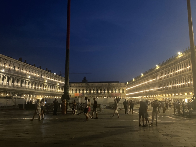       Nighttime view of an illuminated plaza.
  