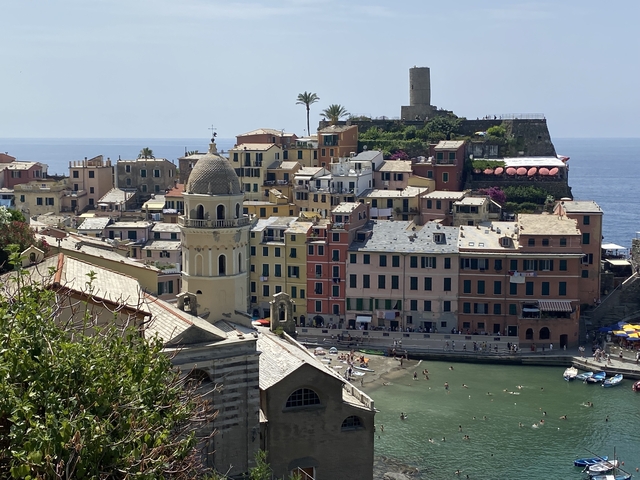       Colorful buildings along a coastal area with a lighthouse.
  