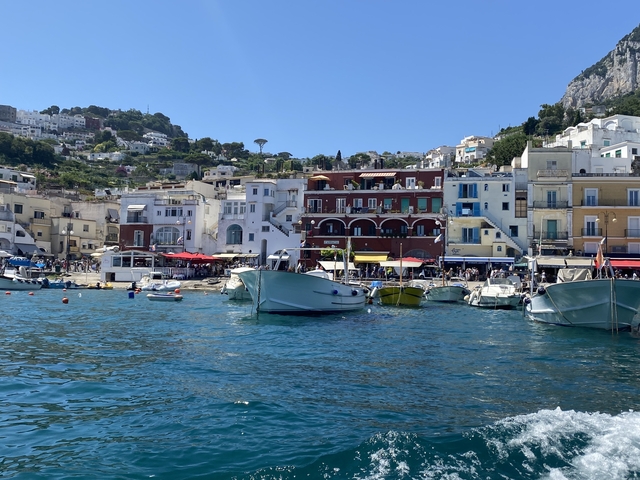Boats docked along a colorful coastal town.