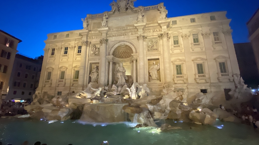       Trevi Fountain lit up at night.
  