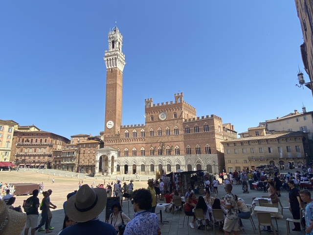       Piazza del Campo in Siena with many people.
  