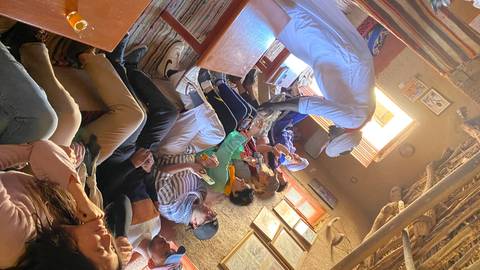 Group of people sitting inside a cultural venue.