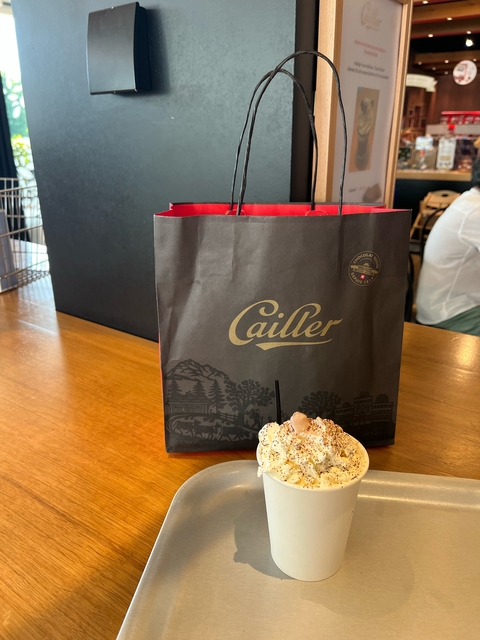 Cailler chocolate shop with a dessert in foreground.