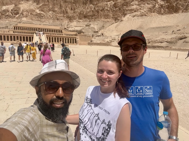 Three people taking a selfie in front of the Mortuary Temple of Hatshepsut.