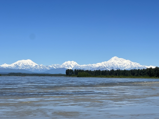       Snow-capped mountains with a river or lake in the foreground.
  