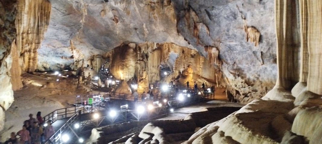A cave with wooden walkways and illuminated rock formations.