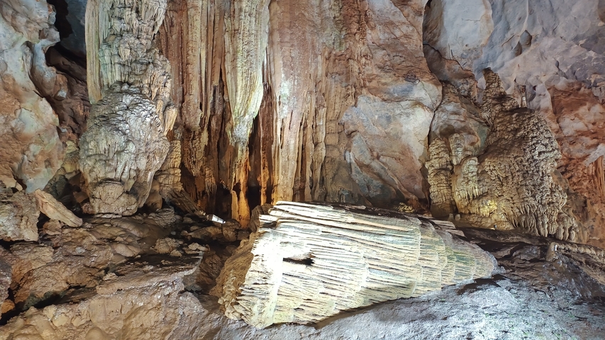 A cave interior featuring striking stalactite formations.