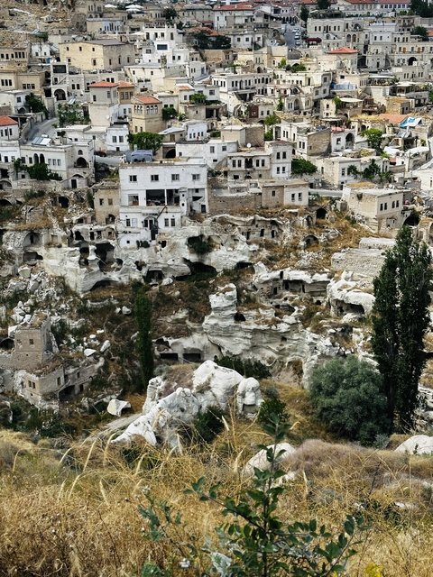 Ancient dwellings carved into rocky terrain.