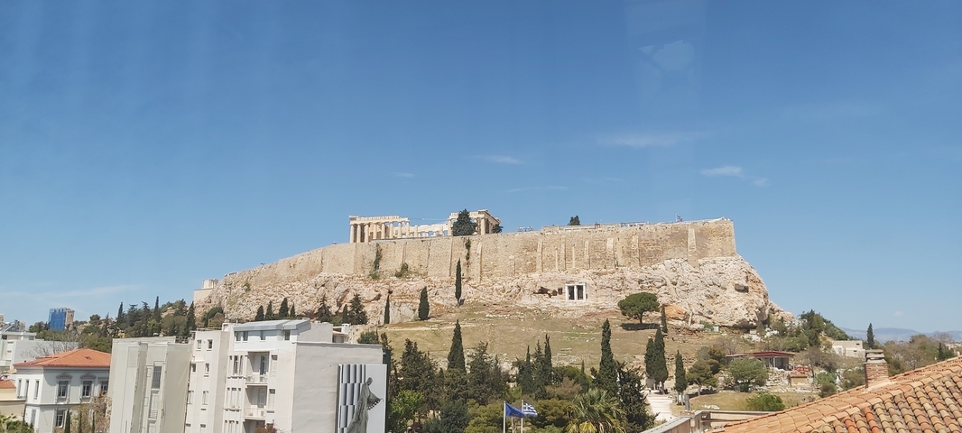 The Acropolis in Athens under a clear blue sky.