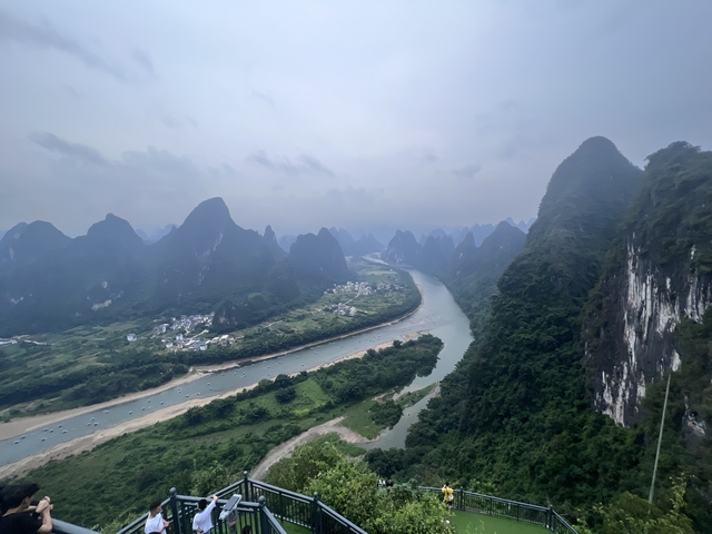 River winding through lush mountainous terrain with overcast skies.