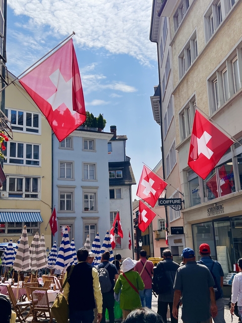 Buildings adorned with Swiss flags, creating a vibrant scene.