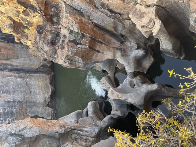       Rock formations with water flowing through them.
  