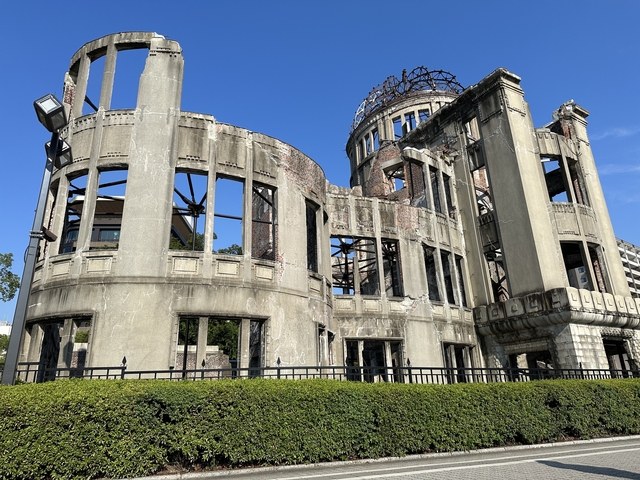       Ruins of the Hiroshima Peace Memorial against a blue sky.
  