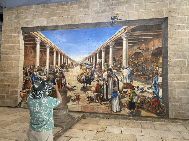       A large mural depicting an ancient market scene.
  