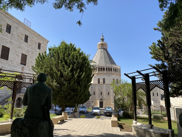 A domed religious building surrounded by trees.