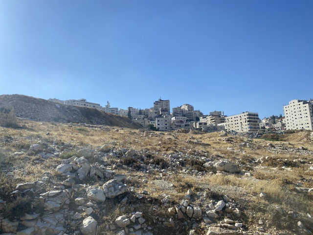       A cluster of buildings on a rocky hillside.
  