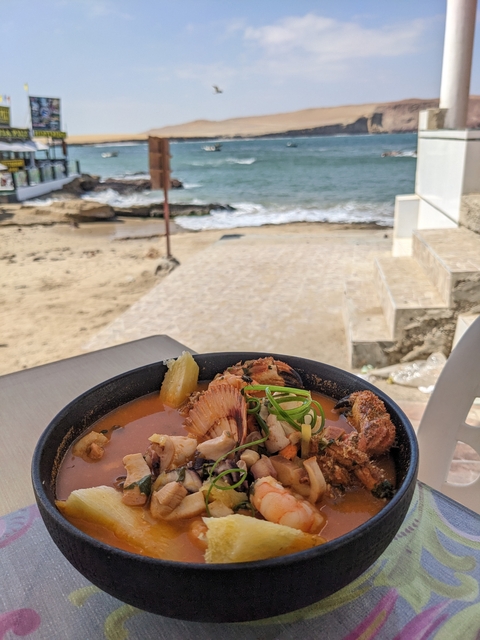 Bowl of seafood soup by the seaside.