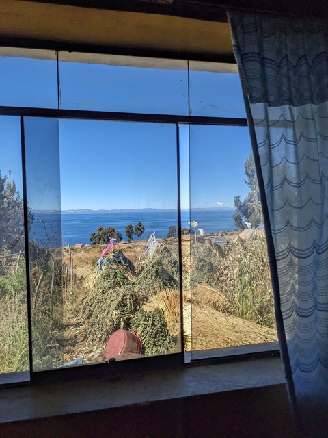 View through a window of a landscape with a lake and trees.
