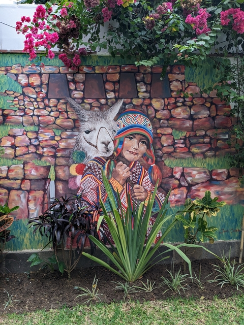 Colorful mural of a child and a llama.