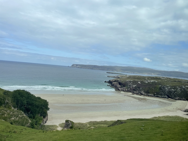       Breathtaking view of a beach and rugged coastline.
  