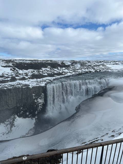 Frozen waterfall with icy formations.