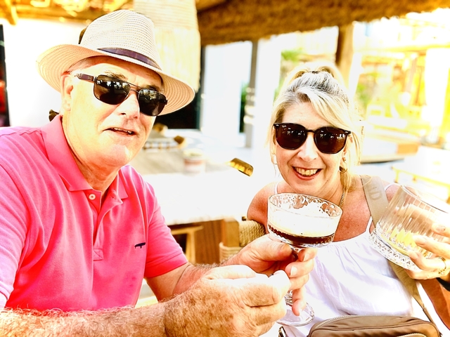       A couple enjoying drinks in a cafe.
  