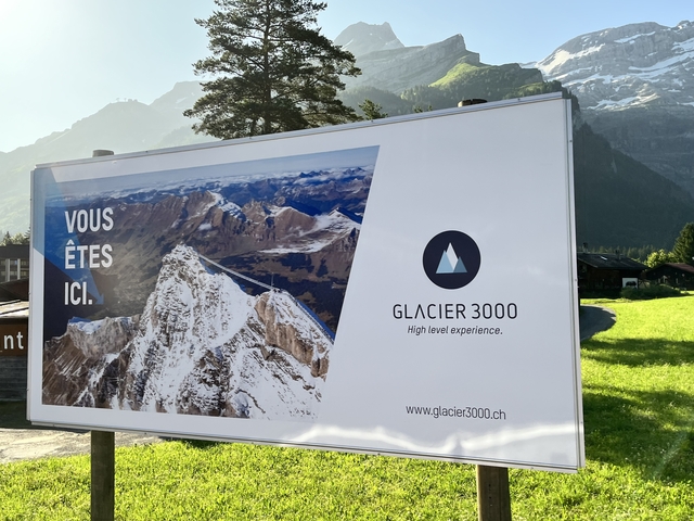       Signboard for Glacier 3000 with a scenic mountain view.
  
