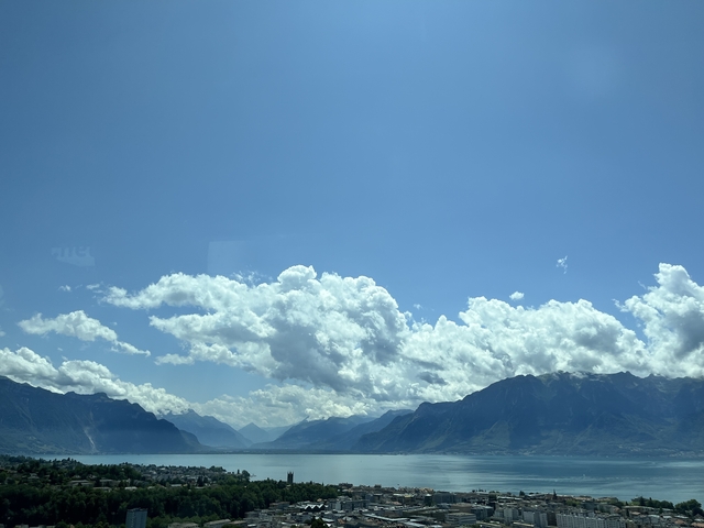      Sky with clouds over mountain scenery.
  