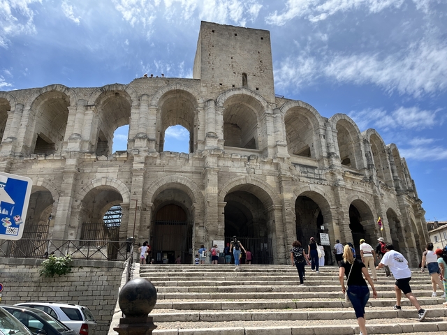       Colosseum in Rome with groups of tourists visiting.
  
